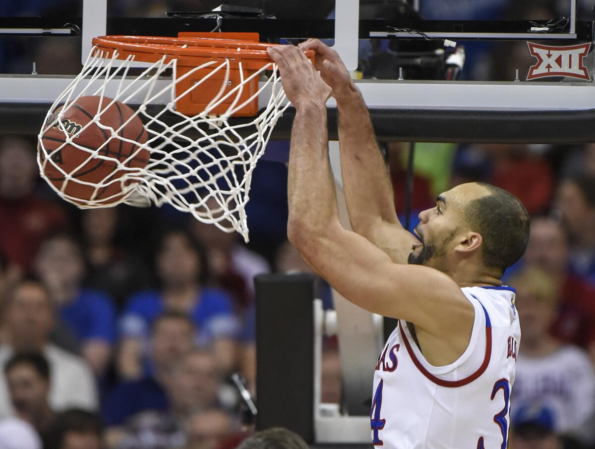 Kansas forward Perry Ellis dunks in the first half of a game against Baylor in the Big 12 tournament.
