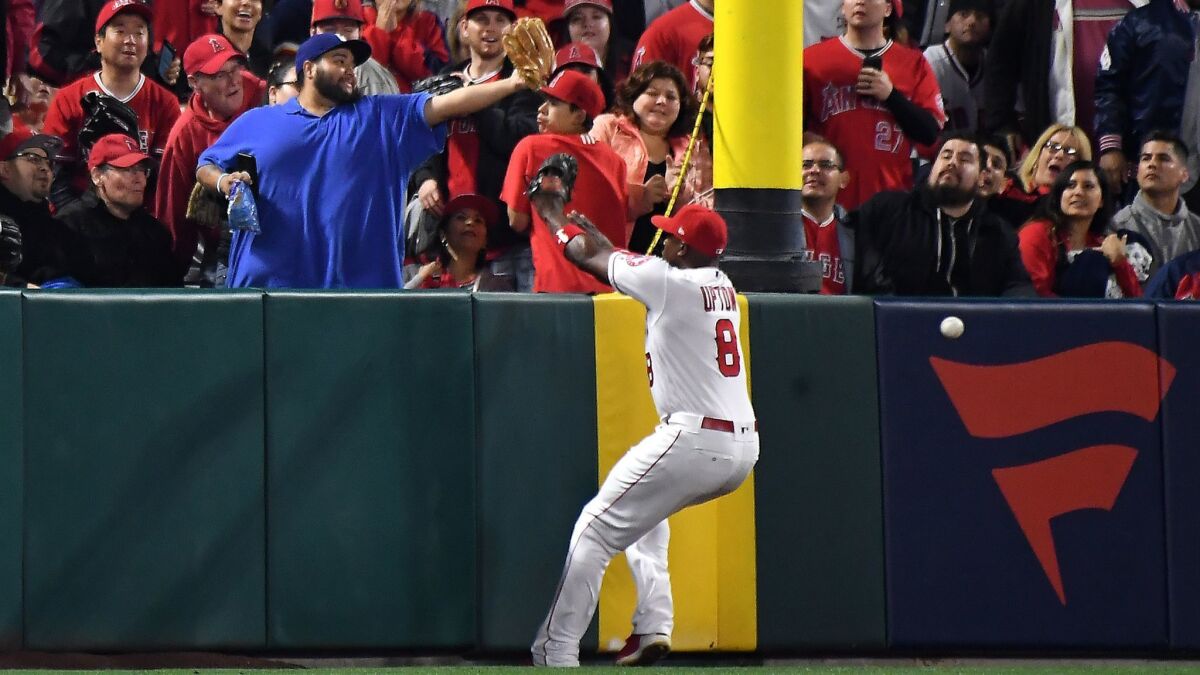 Angels left fielder Justin Upton can't make the catch on an inside-the-park home run by Indians batter Edwin Encarnacion in the second inning on April 2.