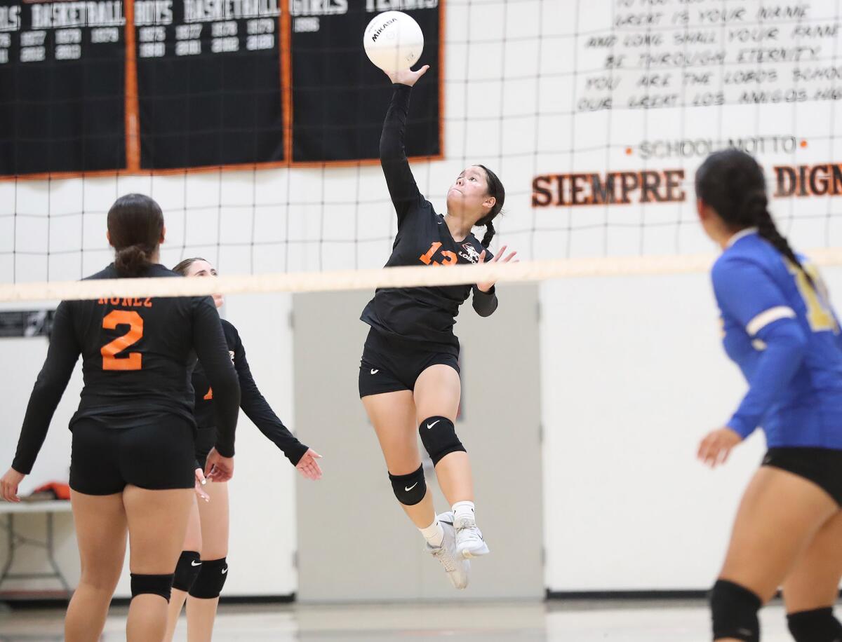 Los Amigos' Mandy Le (13) makes a kill during a long rally in the wildcard round of the CIF Division 8 playoffs on Tuesday.