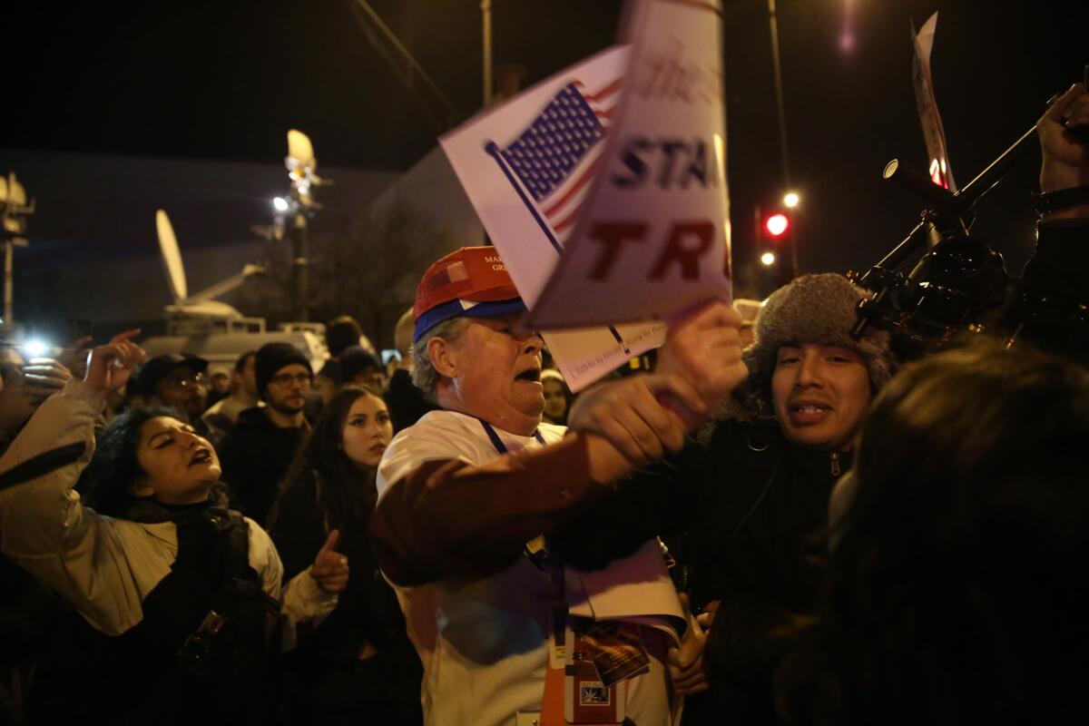 Protesters and Donald Trump supporters struggle outside the UIC Pavilion in Chicago after it was announced that the rally for Republican presidential candidate Donald Trump was canceled March 11, 2016.