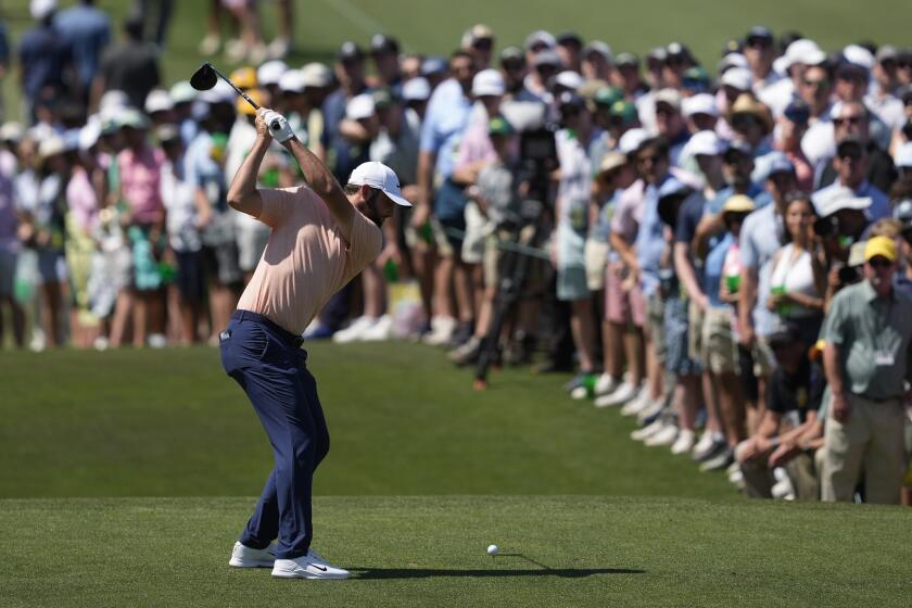 Scottie Scheffler hits his tee shot on the third hole during final round at the Masters golf tournament at Augusta National Golf Club Sunday, April 14, 2024, in Augusta, Ga. (AP Photo/David J. Phillip)