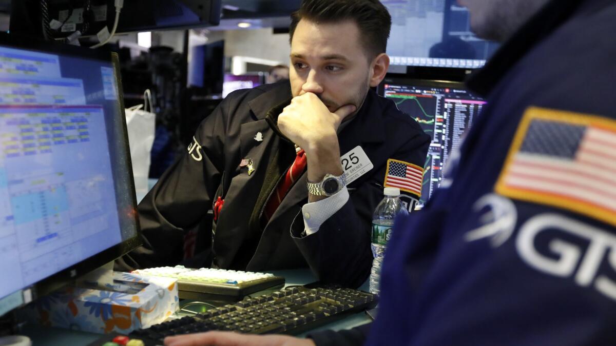 Specialist Matthew Grenier works the floor of the New York Stock Exchange on March 5.