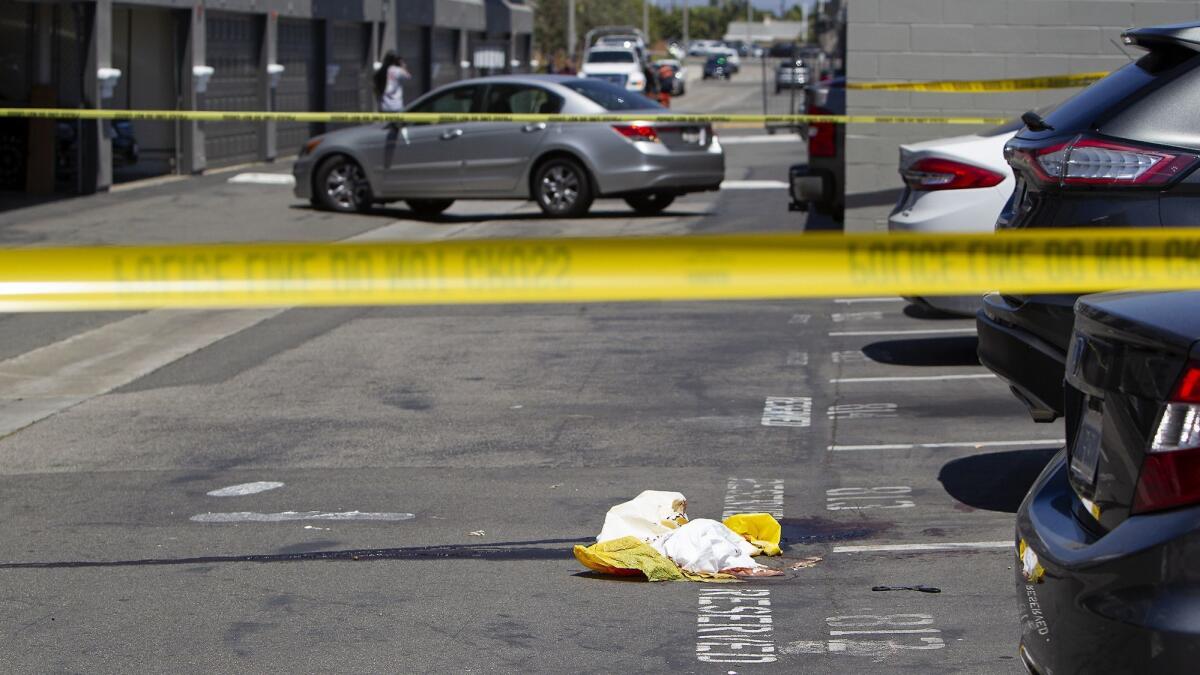 The parking lot of the Breakwater Apartments in Huntington Beach appeared to be stained with blood Monday as police conducted a homicide investigation.