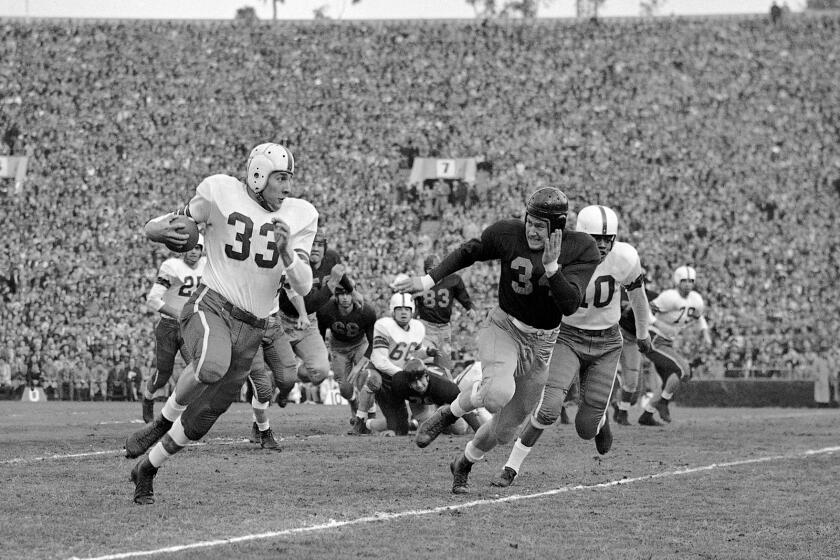 Ohio State fullback Fred Morrison tries to run past California's Paul Baldwin during the 1950 Rose Bowl.