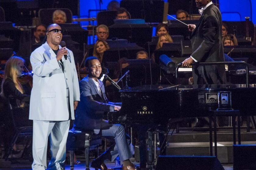 Stevie Wonder, left, and John Legend perform at the Hollywood Bowl, backed by the Hollywood Bowl Orchestra under the baton of Thomas Wilkins.