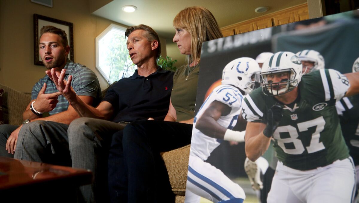 Austin, left, Ralf and Mary Reuland talk about Konrad Reuland, a former NFL tight end who died last December.