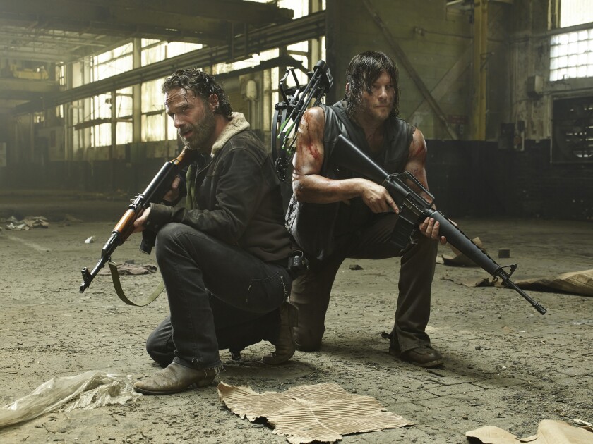 Andrew Lincoln and Norman Reedus star in "The Walking Dead" in the Season 5 premiere. DirecTV subscribers could be in jeopardy of not catching the second half of the season next year should AMC fail in contract negotiations with DirecTV.