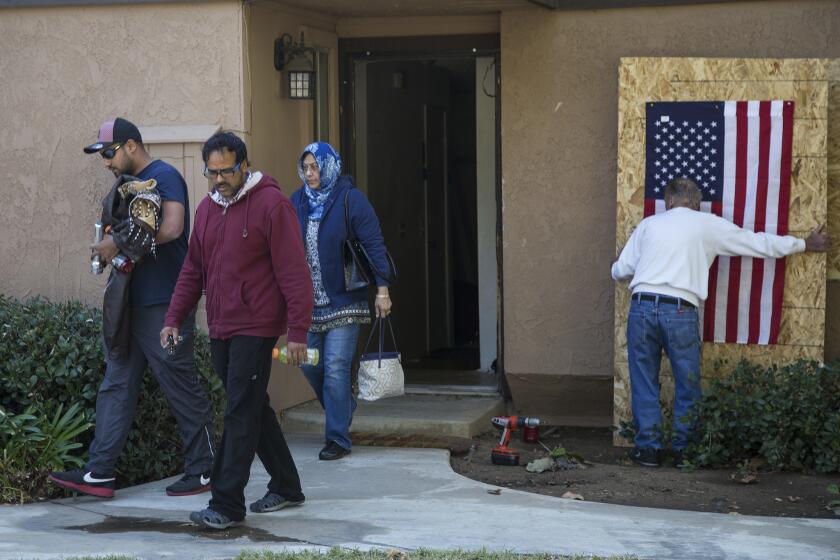 Family members of the San Bernardino shooters on Saturday removed personal items from the couple's rented townhouse in Redlands.