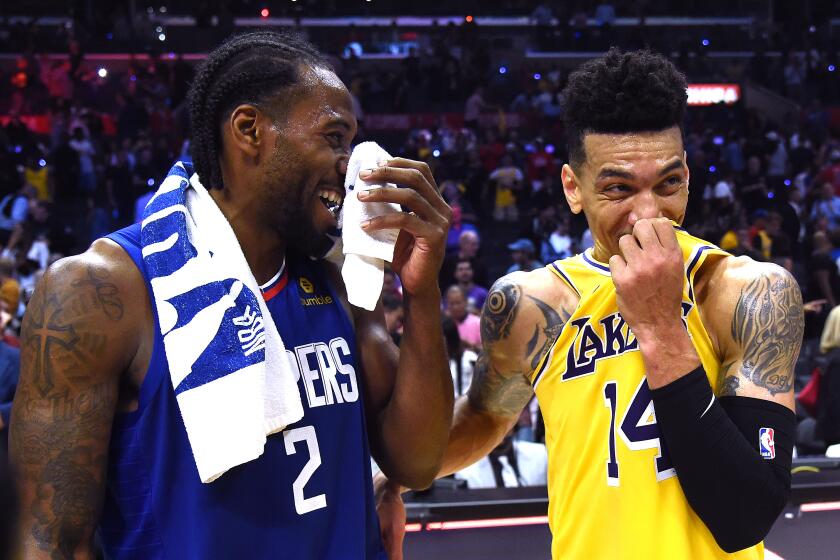 LOS ANGELES, CALIFORNIA - OCTOBER 22: Kawhi Leonard #2 of the LA Clippers and Danny Green #14 of the Los Angeles Lakers laugh after a 112-102 Clippers win during the LA Clippers season home opener at Staples Center on October 22, 2019 in Los Angeles, California. (Photo by Harry How/Getty Images)