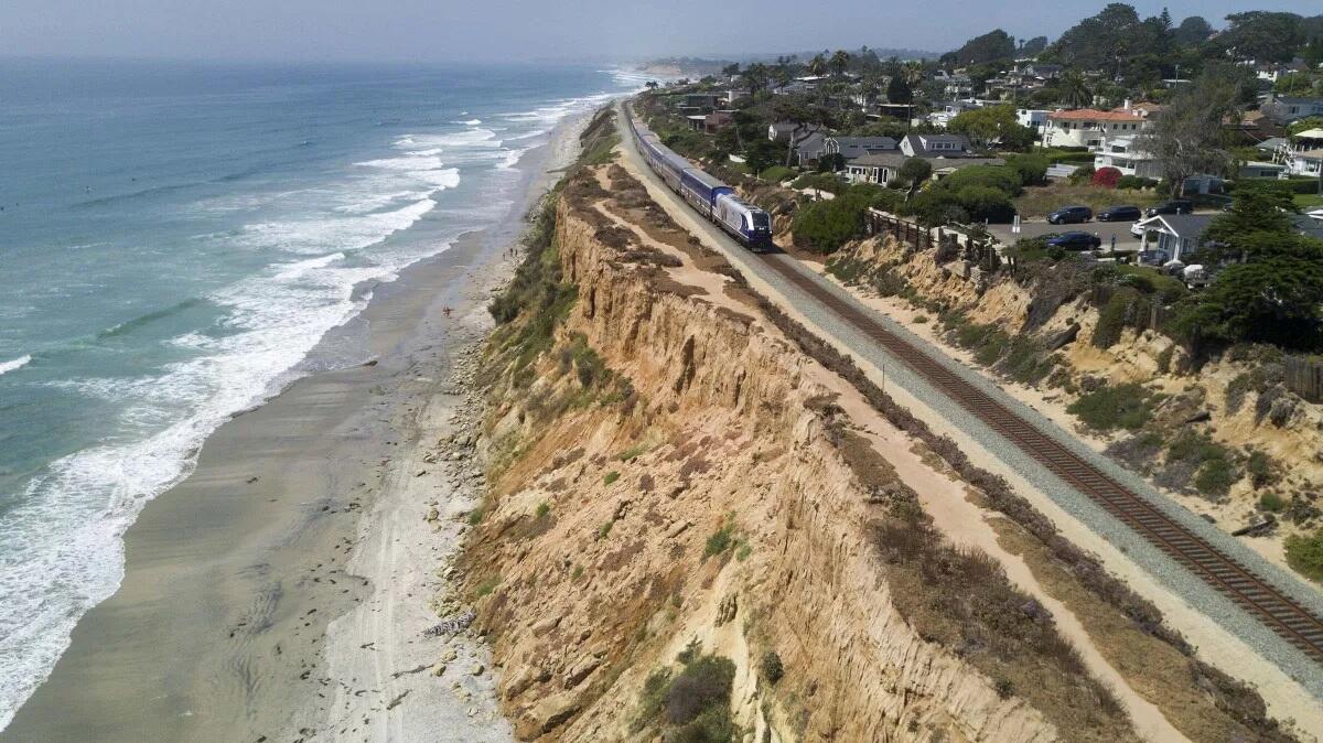 A Surfliner train by Amtrak travels along the collapsing bluffs in Del Mar in 2019.