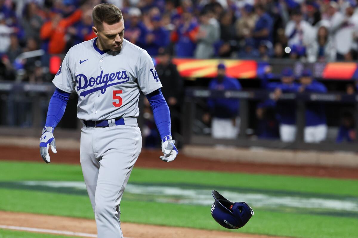 Dodgers first baseman Freddie Freeman tosses his helmet after striking out in the fourth inning.