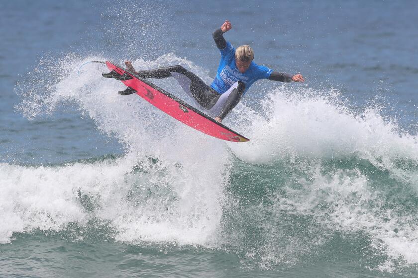 Kolohe Andino of San Clemente completes a high scoring air-reverse as he wins his first heat during the U.S. Open of Surfing men's main draw, at the Huntington Beach Pier on Wednesday.