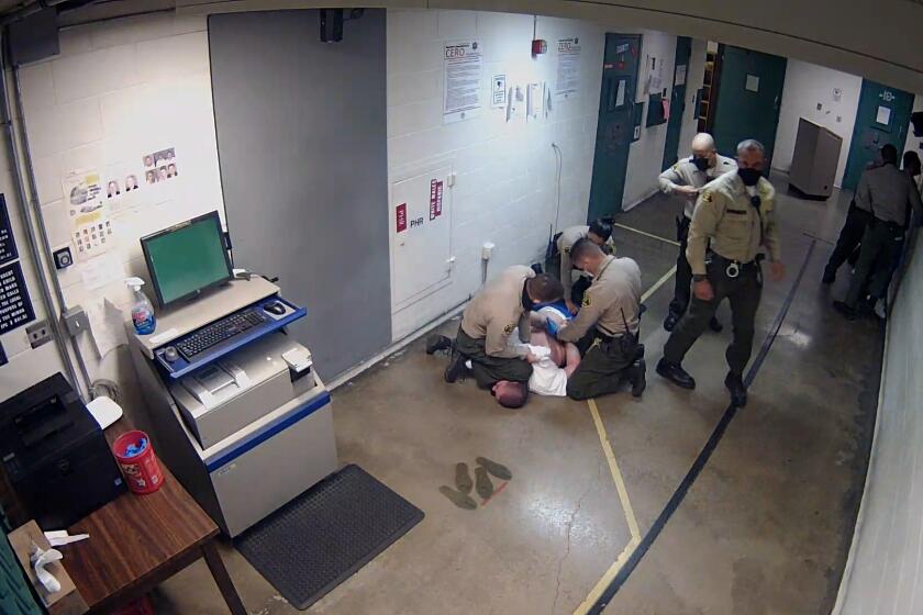 LOS ANGELES, Los Angeles County sheriff’s officials attempted to hide an incident where a deputy knelt on the head of an inmate for three minutes while the man was handcuffed. (SCREENSHOT)
