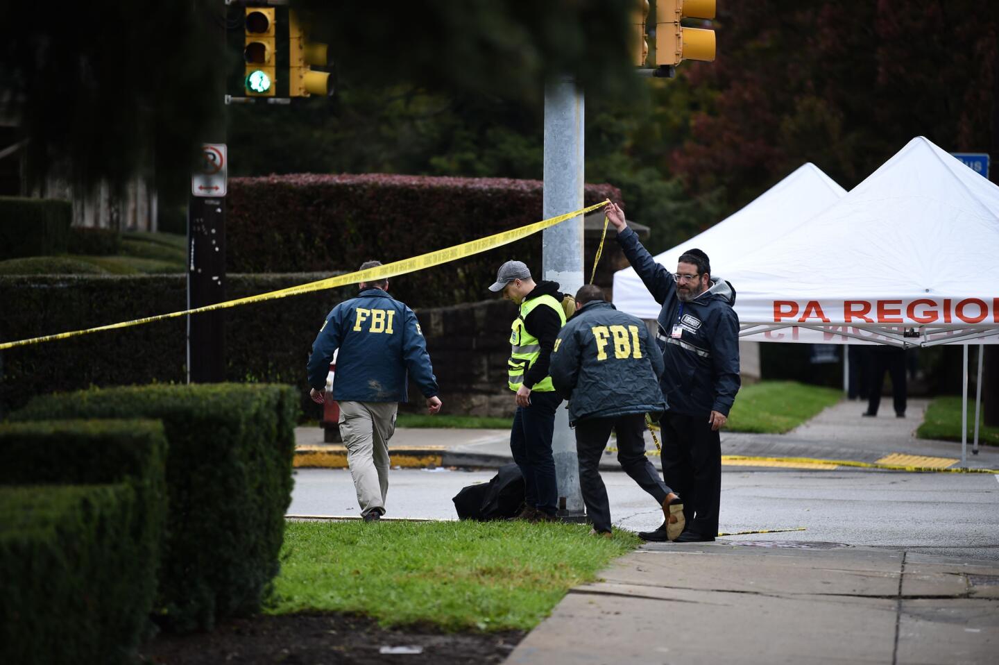 Members of the FBI and others survey the area outside the Tree of Life synagogue on Oct. 28, 2018, after a shooting there left 11 people dead in the Squirrel Hill neighborhood of Pittsburgh.