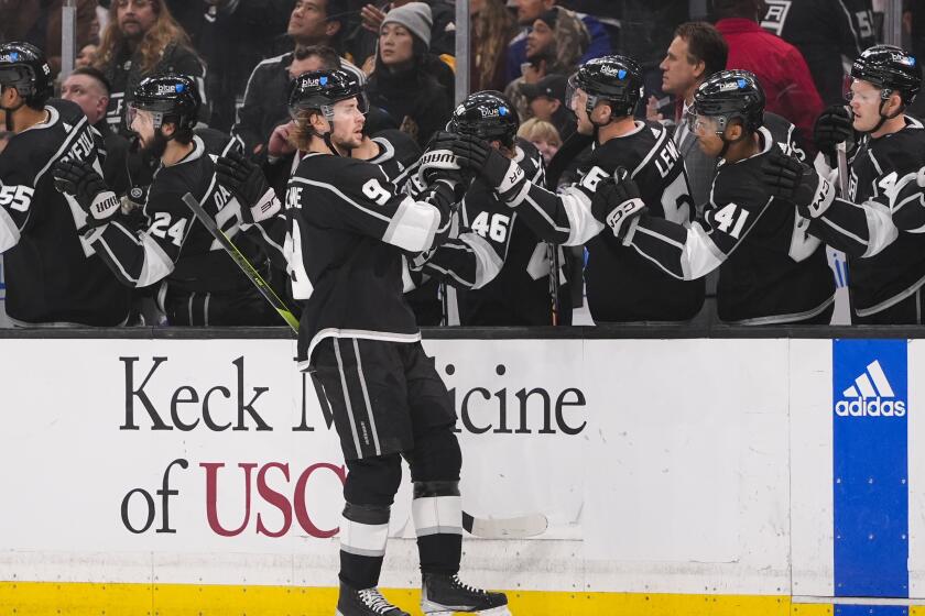 Los Angeles Kings right wing Adrian Kempe celebrates with the bench after scoring.