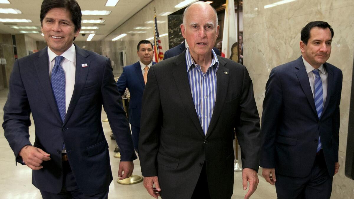 Frim left, Senate President Pro Tem Kevin de León (D-Los Angeles), Gov. Jerry Brown and Assembly Speaker Anthony Rendon (D-Paramount) at the Capitol in Sacramento in July.