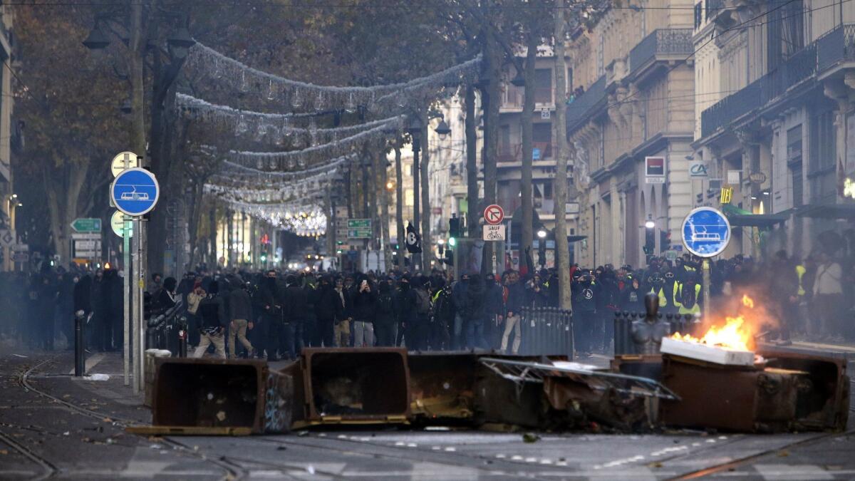 Demonstrators stand behind a burning bin during clashes on Saturday in Marseille, southern France.