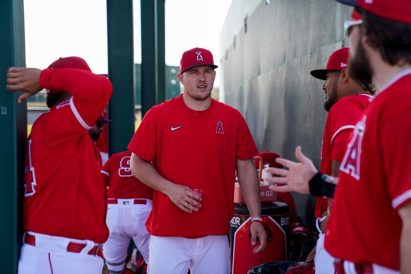 Mike Trout chats with Angels teammates during spring training Tuesday in Tempe, Ariz.