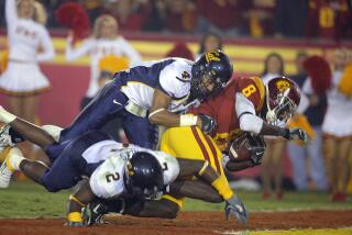 USC receiver Dwayne Jarrett scores a touchdown as he is tackled by California's Thomas DeCoud and Bernard Hicks