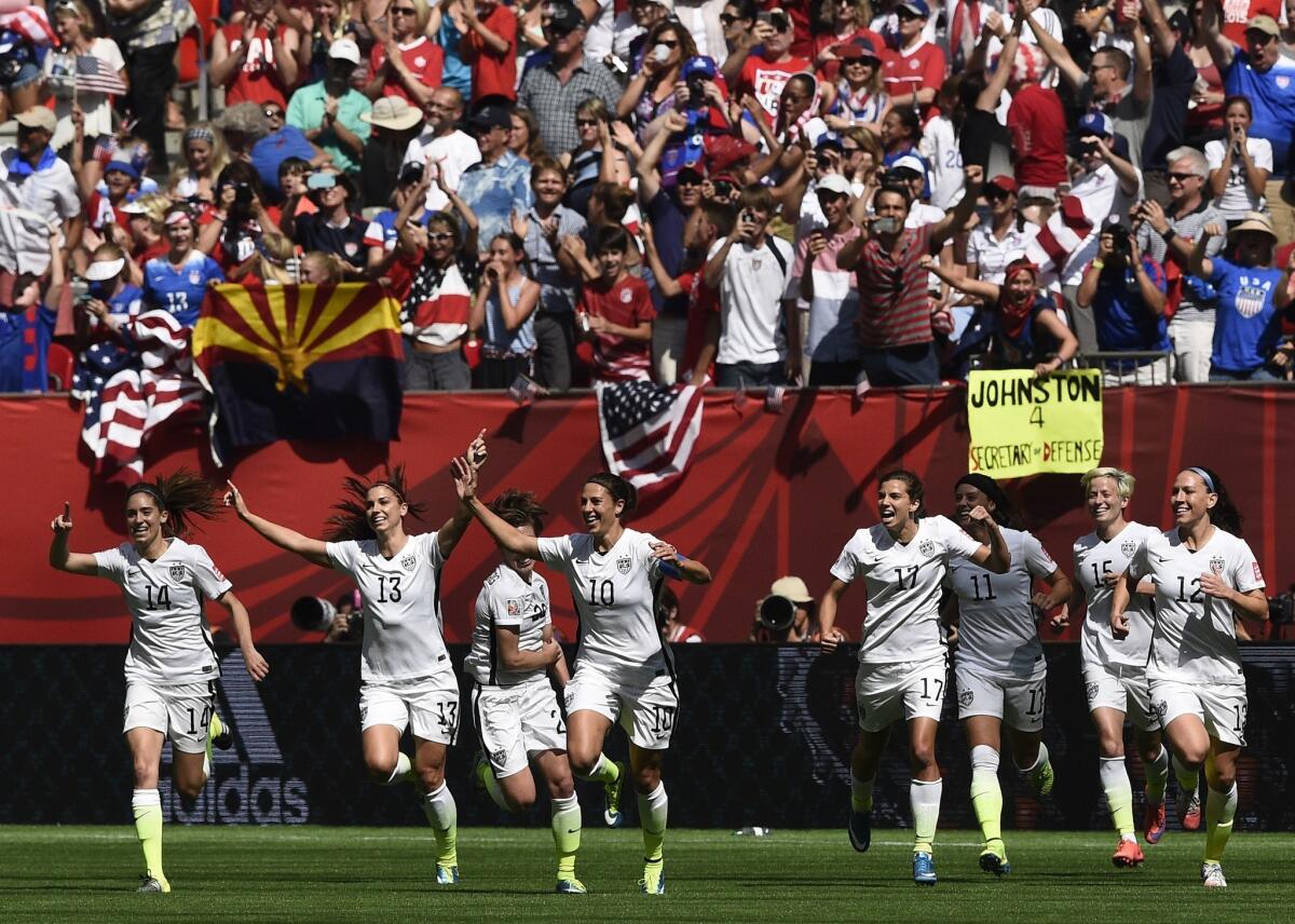 Midfielder Carli Lloyd (10) and he United States teammates celebrate one of her three goals in the Women's World Cup Final against Japan.