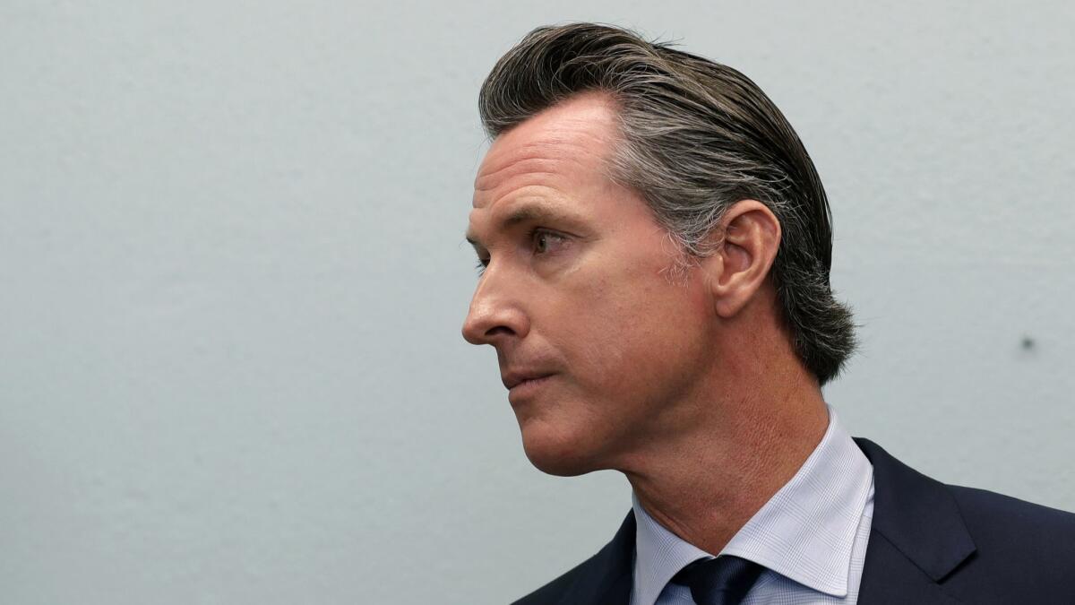 Governor-elect Gavin Newsom looks on during a news conference near the border on Nov. 29, 2018, in San Diego.