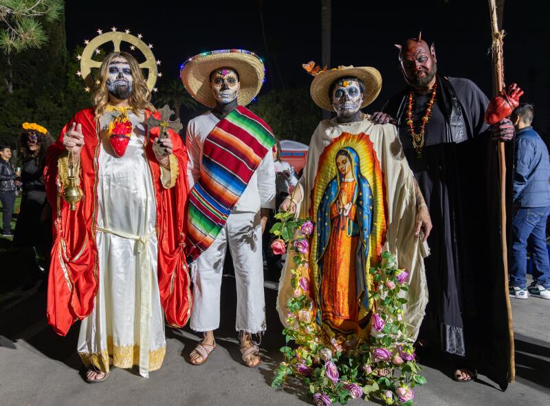 Four men pose for a photo in their costumes