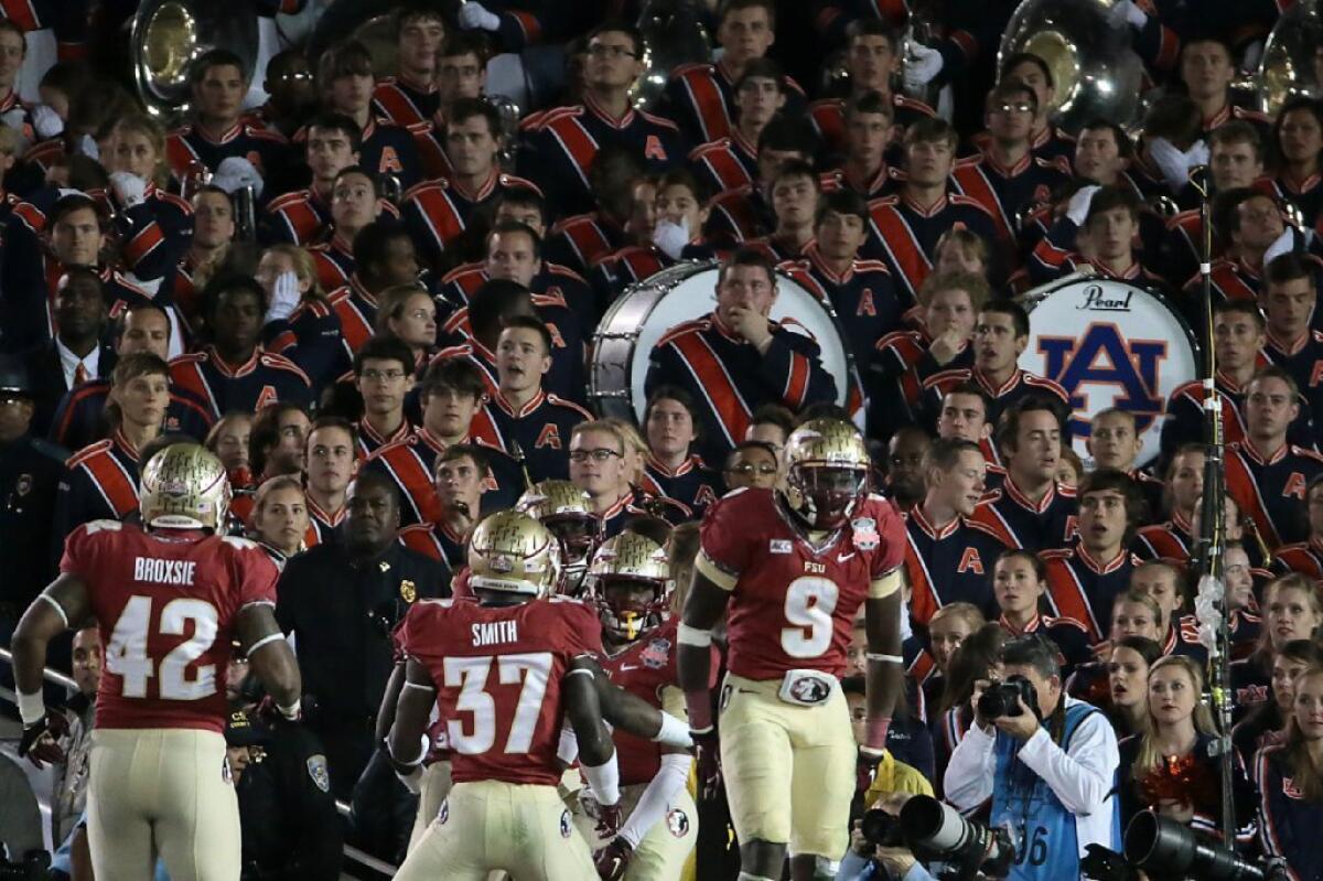 Stunned Auburn band members look on as Florida State celebrates a 100-yard kickoff return by freshman Levonte Whitflield late in the fourth quarter of the BCS Championship game. While Florida State of the ACC defeated Auburn of the SEC, the SEC led all conferences with seven teams in the final top 25 and the ACC had three.