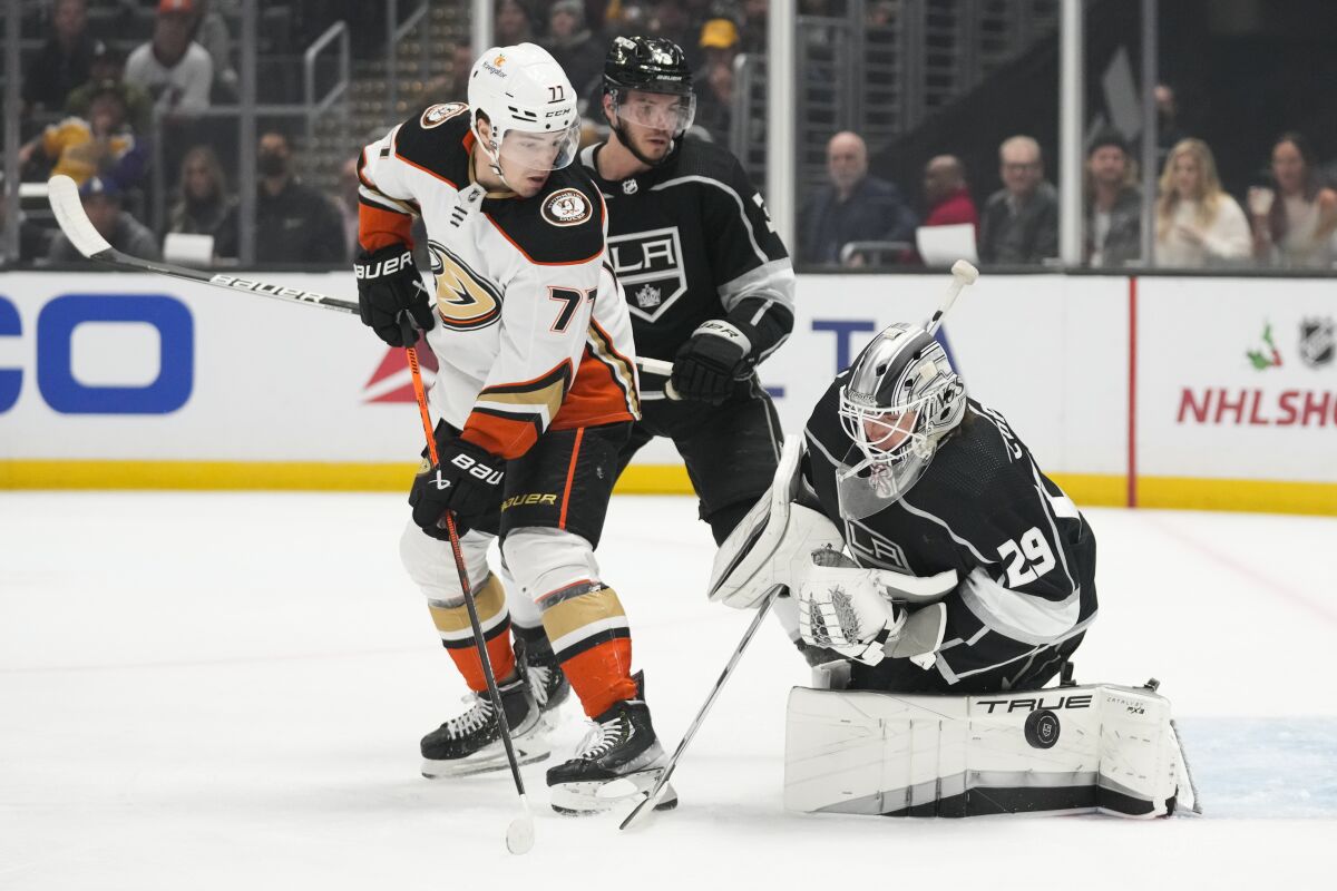 Kings goaltender Pheonix Copley leans to his right to stops a shot in front of Duck Frank Vatrano and King Matt Roy