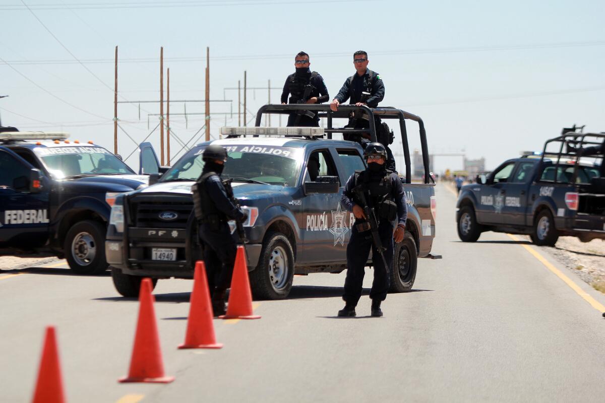Mexican federal police guard a road near the Cuidad Juarez prison where Guzman was moved.
