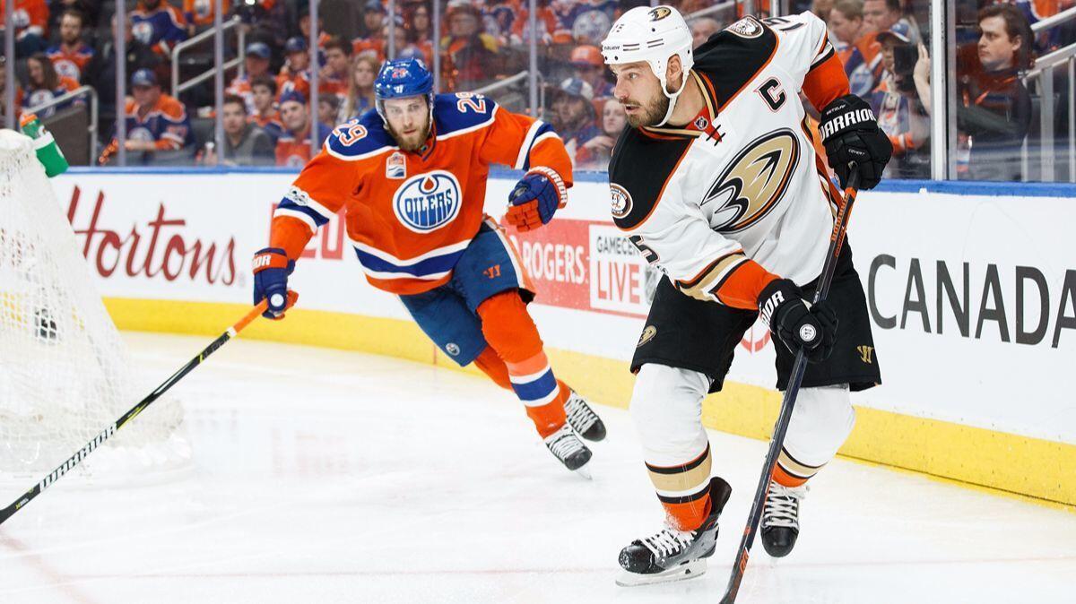 Ducks center Ryan Getzlaf looks to pass as he's pursued by Oilers center Leon Draisaitl during Game 6 on Sunday.