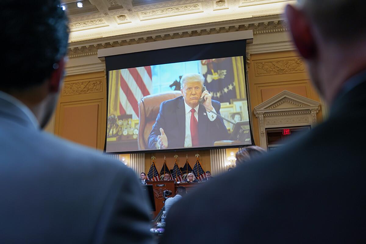 President Trump is seen on a video screen.