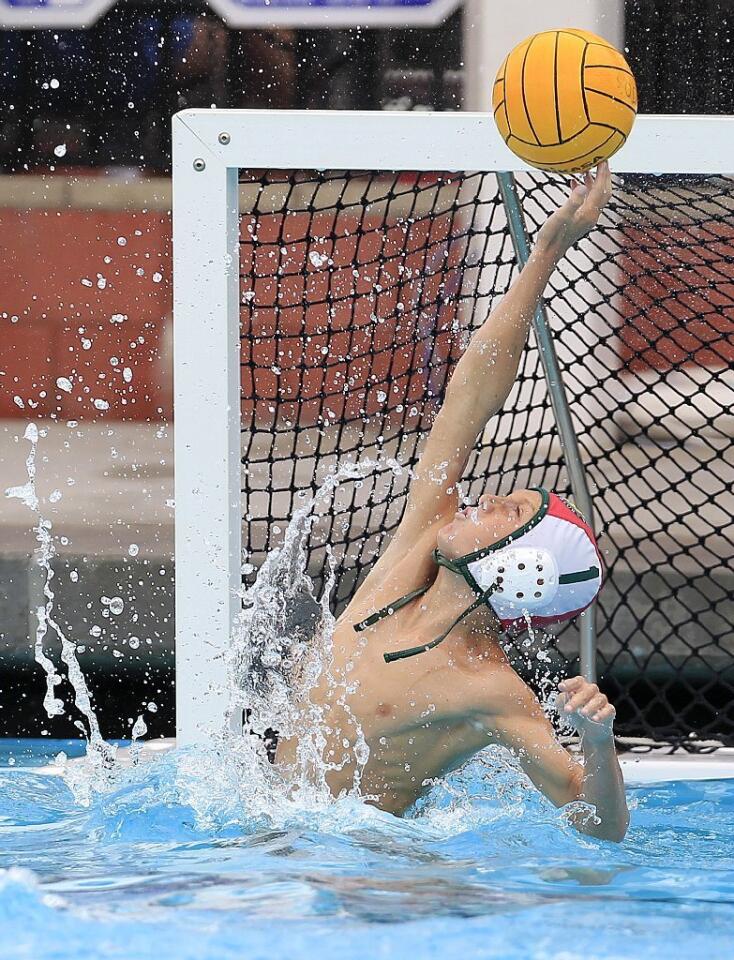 Costa Mesa Aquatics Club goalie Kevin Johnson reaches up for a block against the Los Angeles Water Polo Club during a USA Junior Olympics semifinal match at Mater Dei High School in Santa Ana on Tuesday.