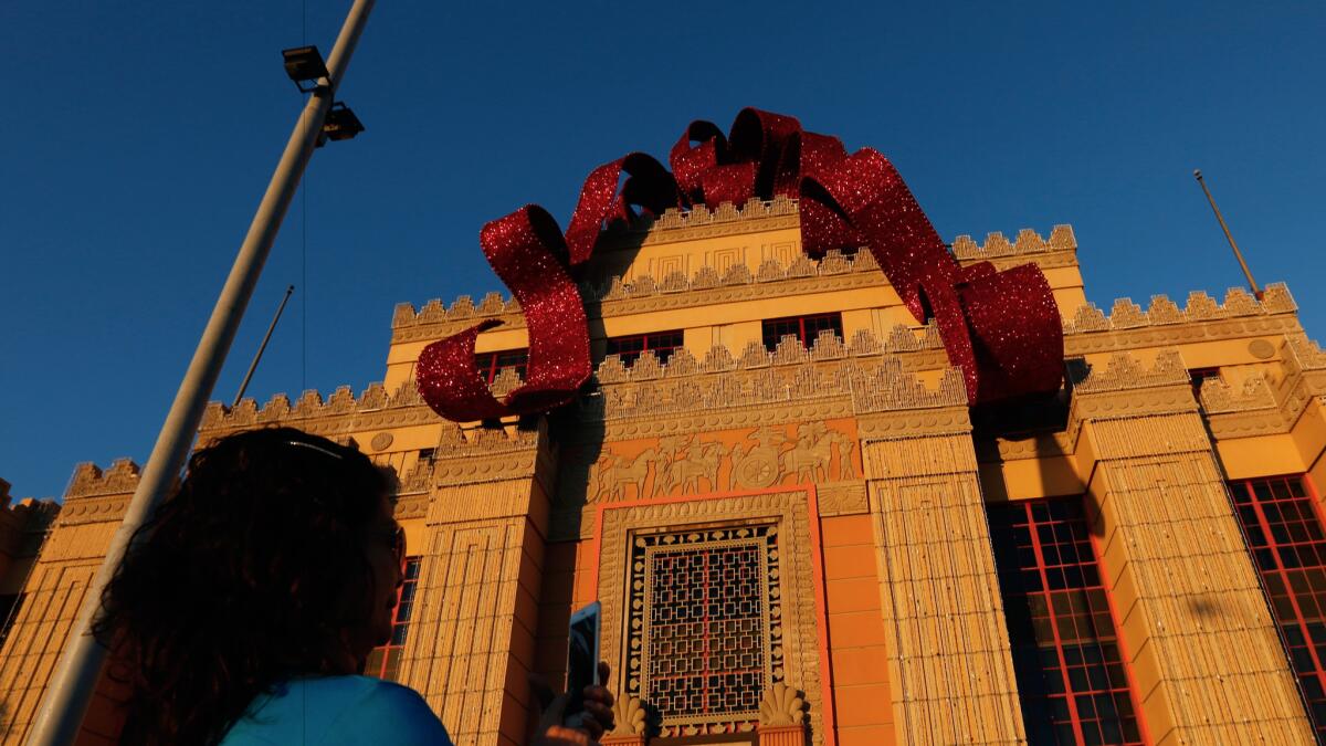 Is it that time already? A visitor snaps a photo beneath the Citadel Outlets' Christmas bow.