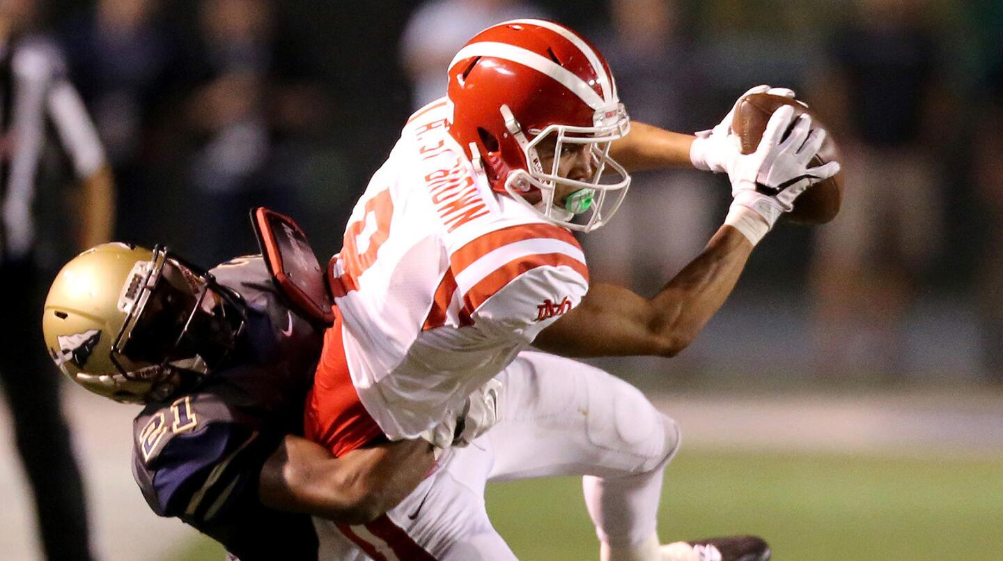 Mater Dei receiver Amon-Ra St. Brown makes a catch against St. John Bosco defensive back Level Price during the first half Friday, Oct. 21.