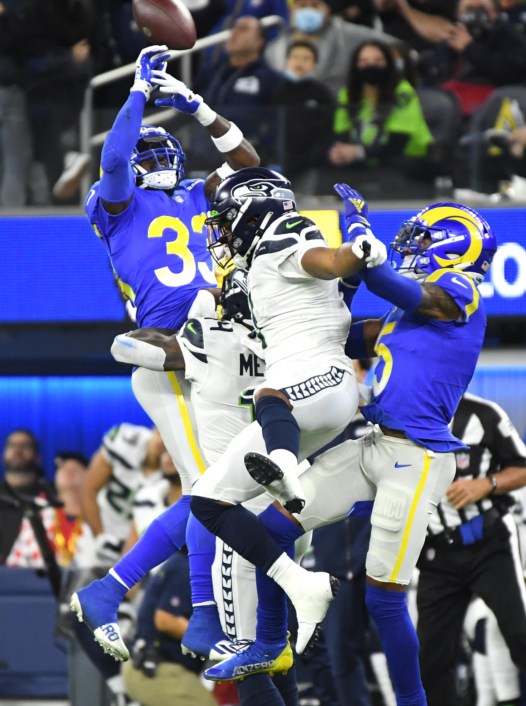 Rams safety Nick Scott deflects a pass intended for Seahawks wide receivers in the fourth quarter.
