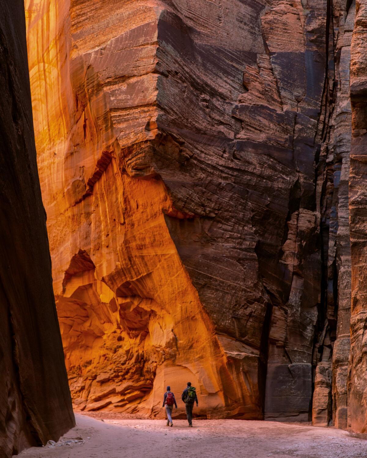 Photo of the massive red sandstone walls of Buckskin Gulch, Utah.