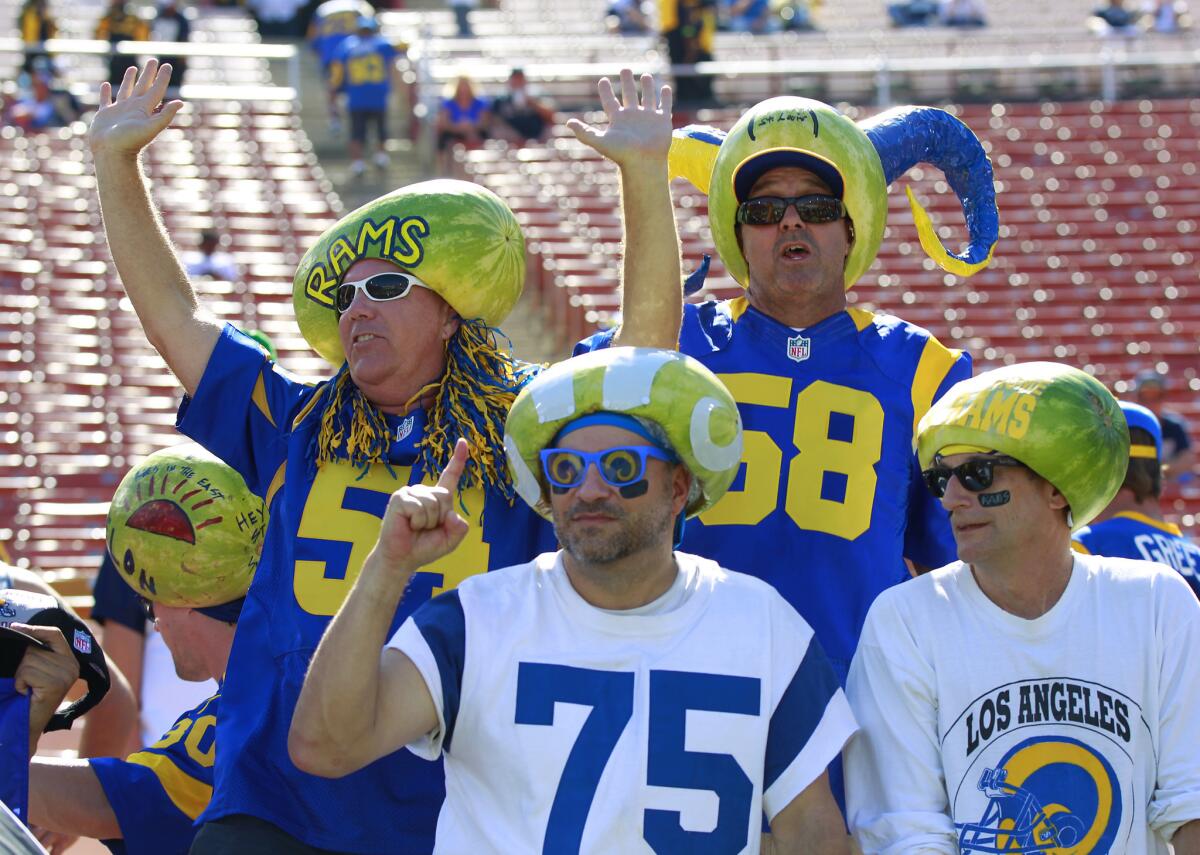 The Melonheads, part of Rams lore, cheer before the start of the exhibition game Aug. 12 against the Dallas Cowboys at the Coliseum.