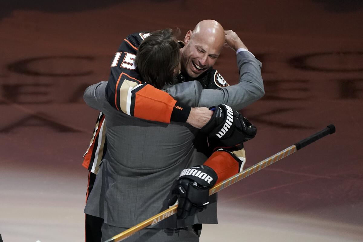 Anaheim Ducks' Ryan Getzlaf hugs his former teammate Teemu Selanne during a pre-game event.
