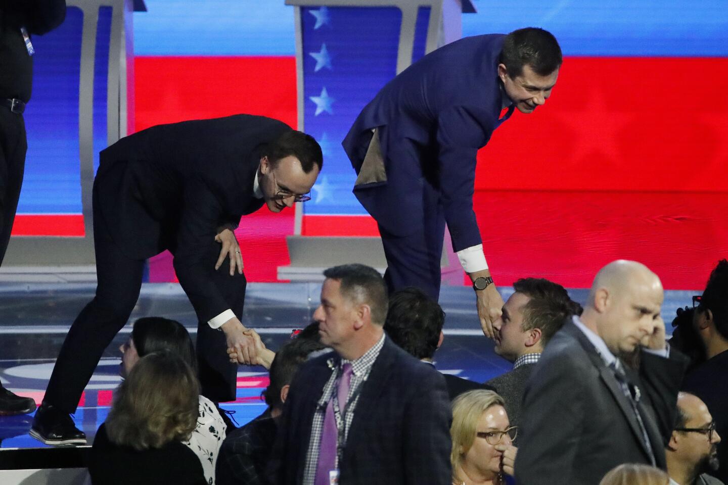 Former South Bend, Ind., Mayor Pete Buttigieg, right, and his husband, Chasten Buttigieg, shake hands with members of the audience after the Democratic presidential primary debate.