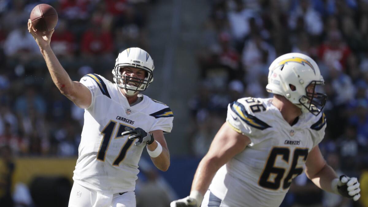 Chargers quarterback Philip Rivers launches a pass while being protected by offensive lineman Dan Feeney against the Chiefs.