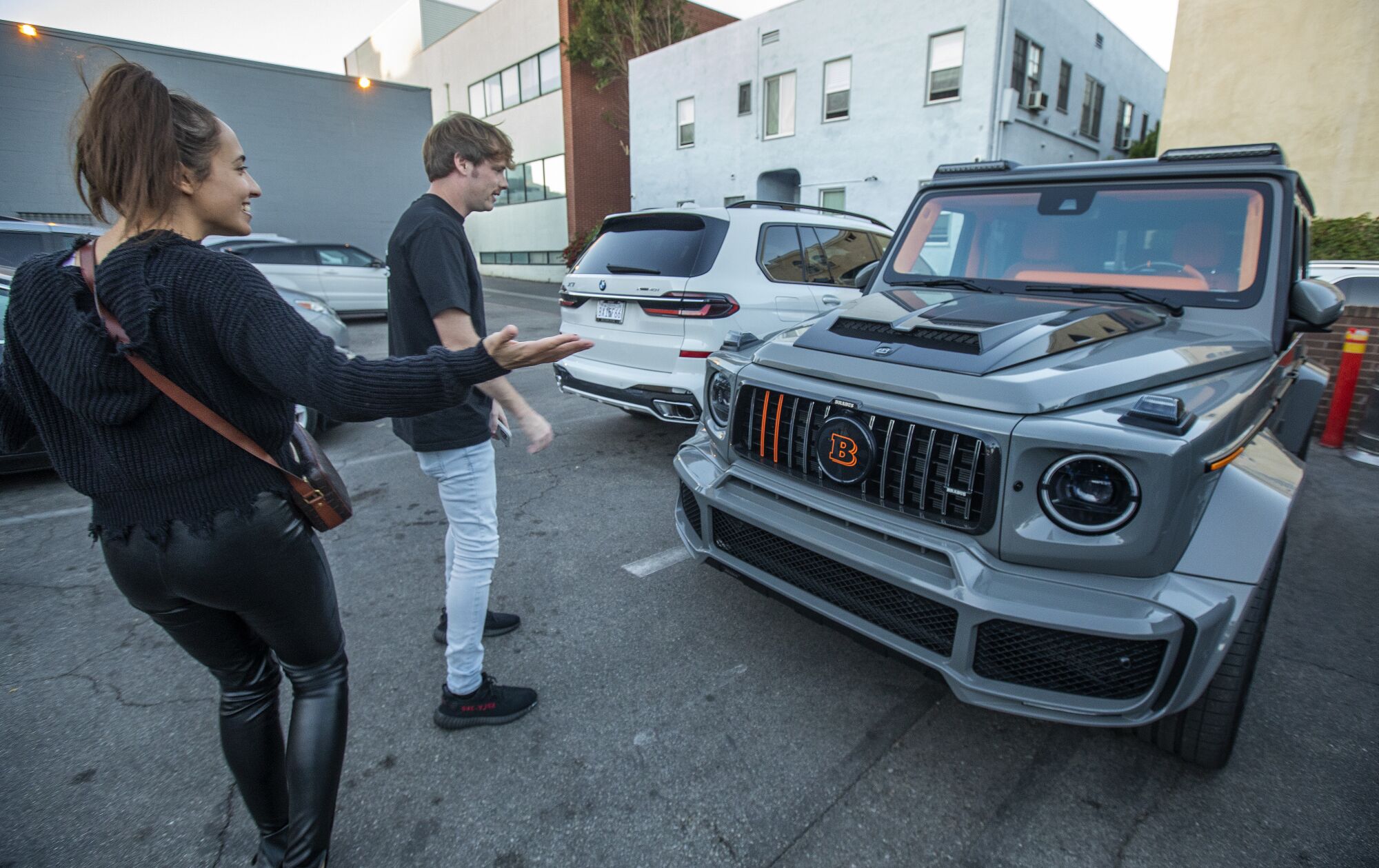 Jenna DeMaio, a celebrity wardrobe stylist, shows Daniel MacDonald her Brabus