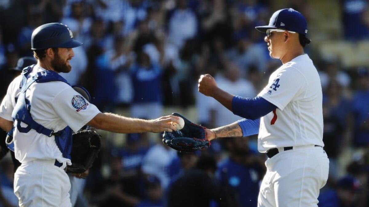 Dodgers relief pitcher Julio Urias gets the game ball from catcher Rocky Gale after a game against San Diego this season.