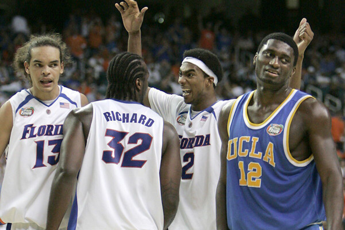 UCLA center Alfred Aboya endures a Florida celebration in the closing moments of a 76-66 loss to Florida in the NCAA Final Four.