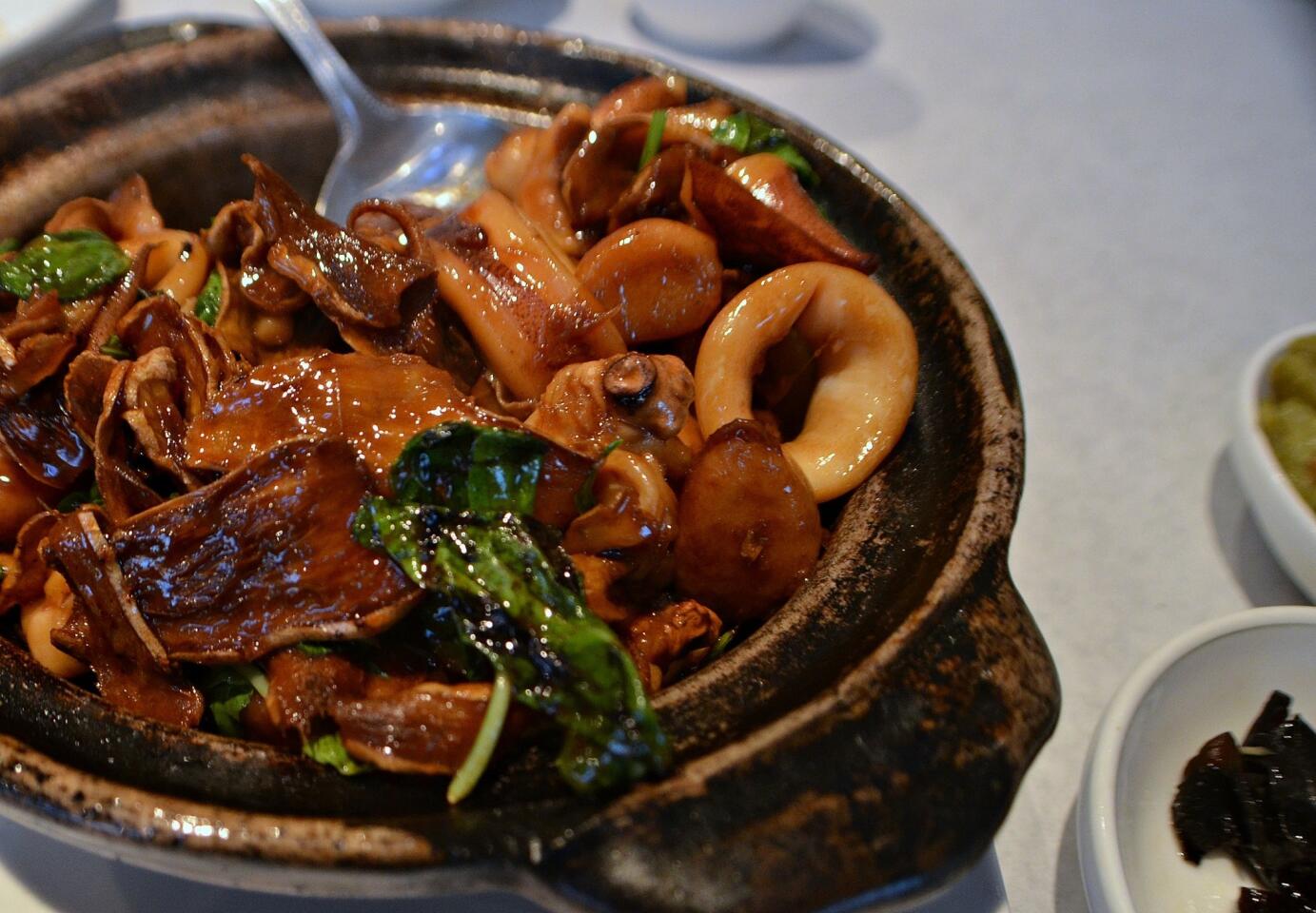 "Three cups" squid with black sesame oil, garlic and ginger. This goes fantastic with a bowl of white rice.