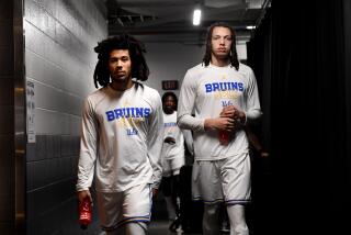 Sacramento California March 16, 2023-UCLA's Tyger Campbell, left, and Mac Etienne walk.