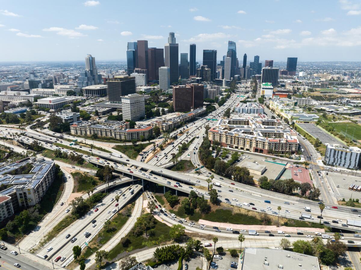 Los Angeles skyline and the four-level interchange where the 110 and 101 freeways meet. Photographed in Los Angeles, CA.