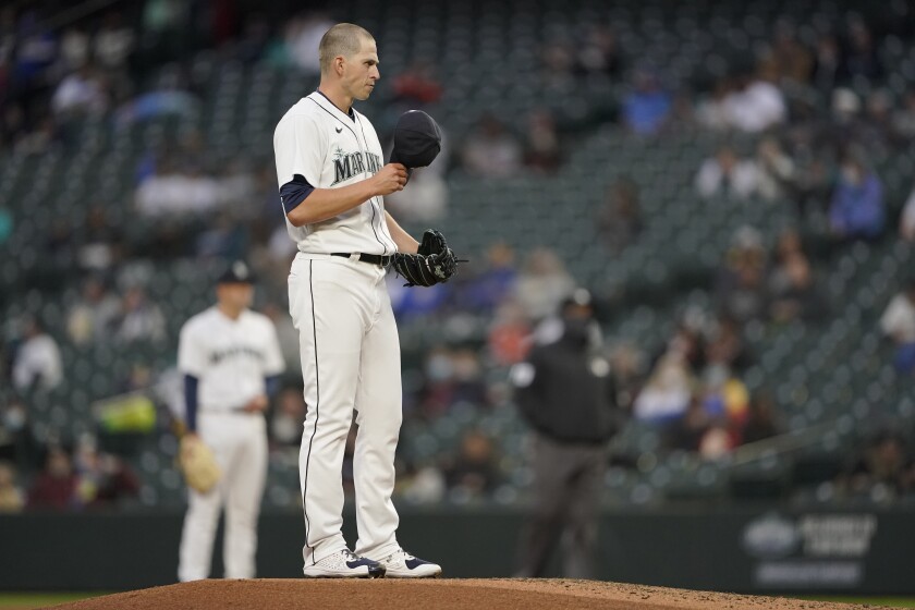 Seattle Mariners starting pitcher Chris Flexen pauses on the mound during the third inning of the team's baseball game against the San Francisco Giants, Saturday, April 3, 2021, in Seattle. (AP Photo/Ted S. Warren)