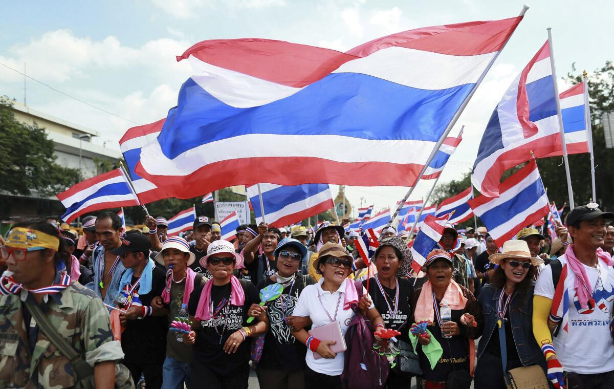 Anti-government protesters march to the Defense Ministry in Bangkok, Thailand, on Thursday.
