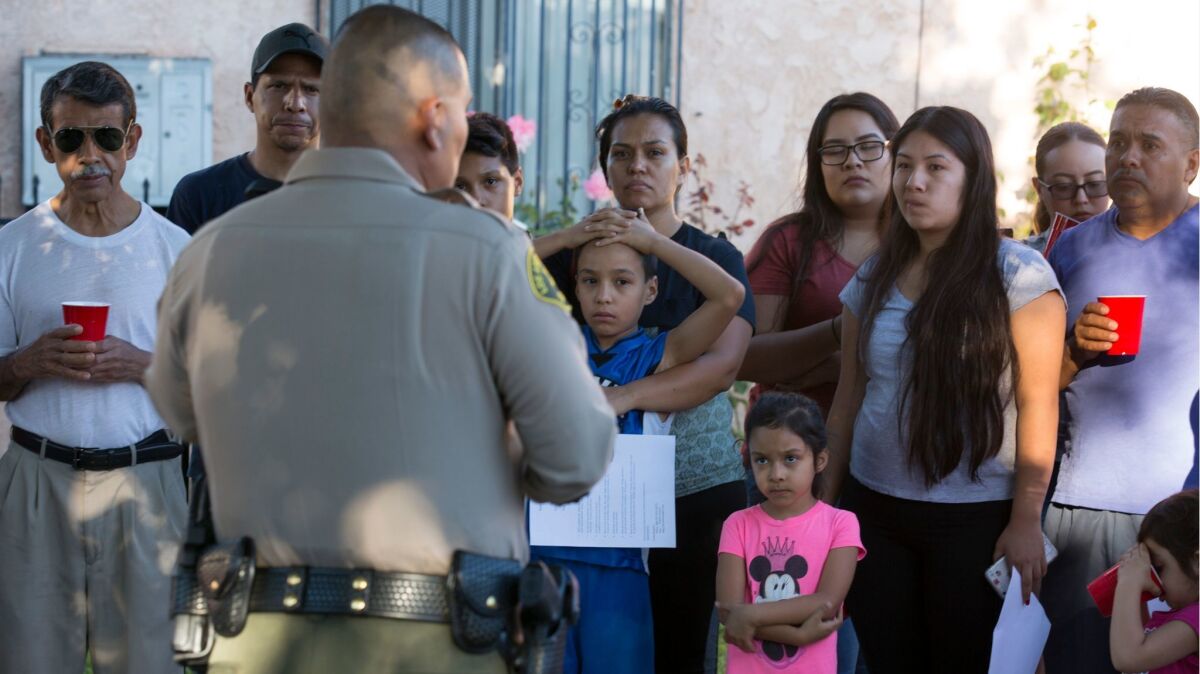 Sheriff's Deputy Marino Gonzalez talks with community members during a block meeting in Cudahy.