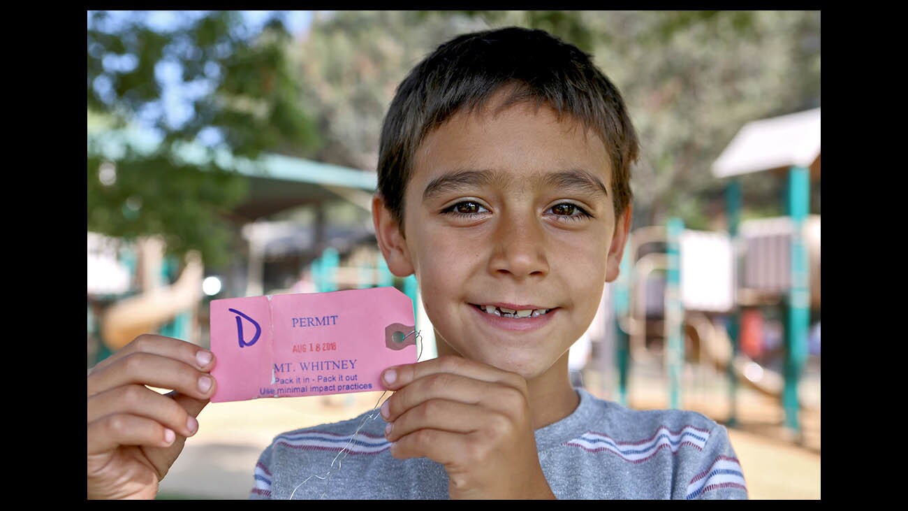 Eight year old Joshua LoCicero shows his Mt. Whitney permit, at Memorial Park in La Canada Flintridge on Saturday, Aug. 25, 2018. The La Canada Elementary School third grader reached the summit of Mt. Whitney, alongside his mother and five other hikers, on Saturday, Aug. 18, 2018 and is thought to me the second youngest person to make the 22-mile hike in one 24-hr. period. It took LoCicero 23 hours to complete the roundtrip trek.